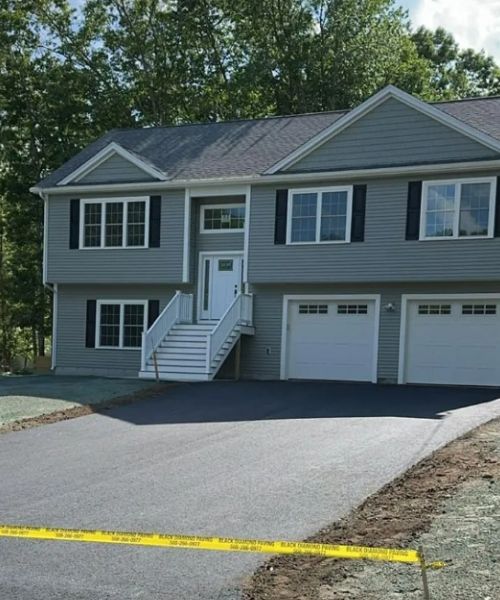 A two story house with a large driveway