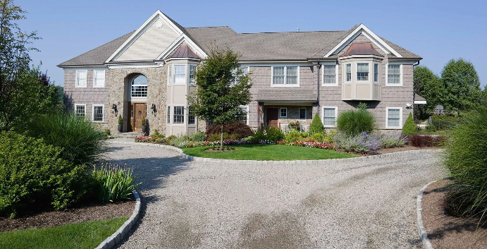 A large house with a driveway in front of it